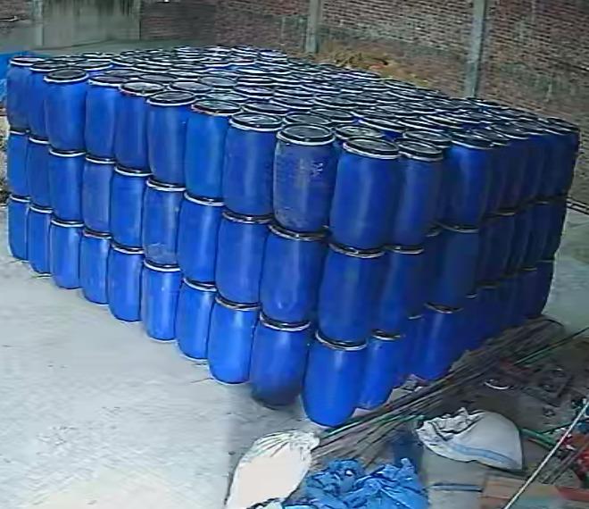Organized blue feed storage drums at farm
